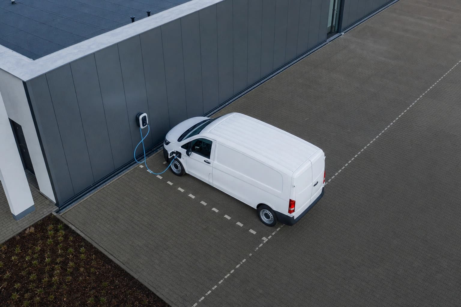 Electric company vehicle at a wallbox